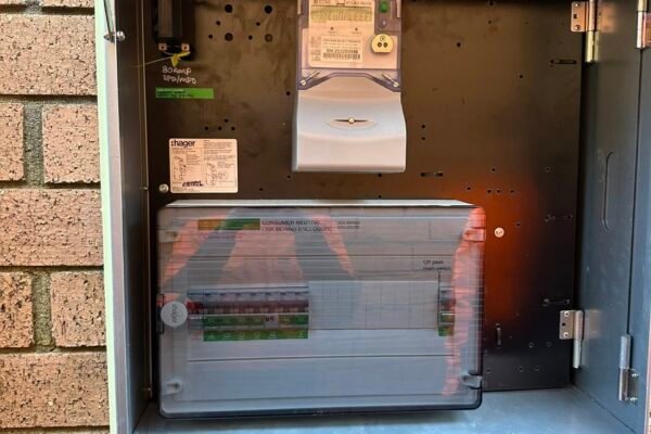 Open switchboard meter box mounted on a brick wall – Marmont Electrical