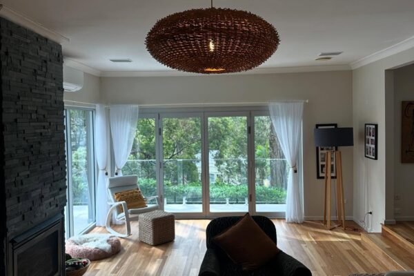 Woven rattan pendant light fitting in a living room – Marmont Electrical