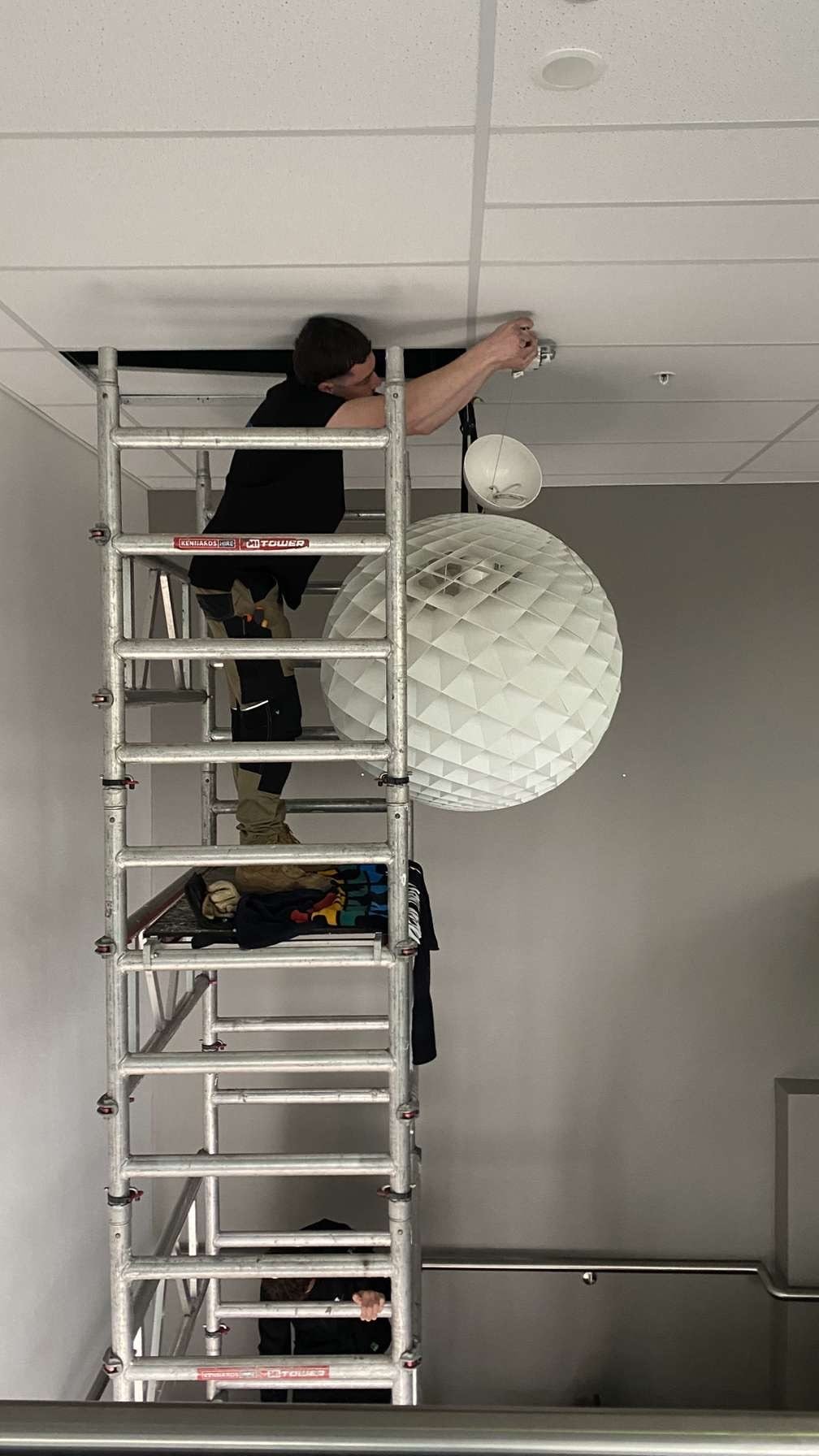 Marmont Electrical installing a designer pendant light from a scaffold — Northern Beaches