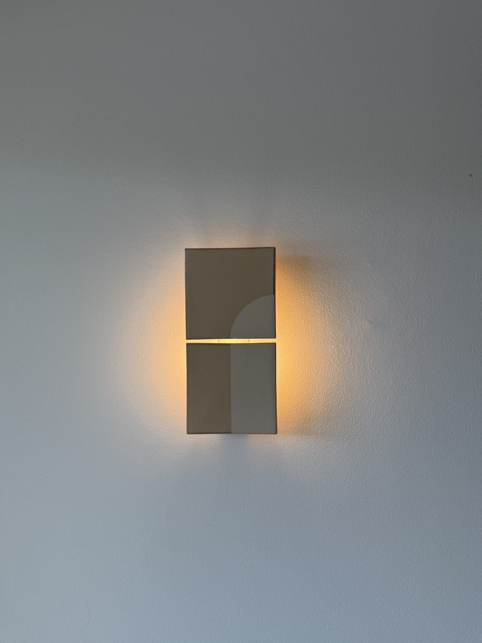 Warm architectural wall sconce installed by Marmont Electrical